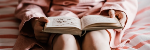 a child with a book on her lap